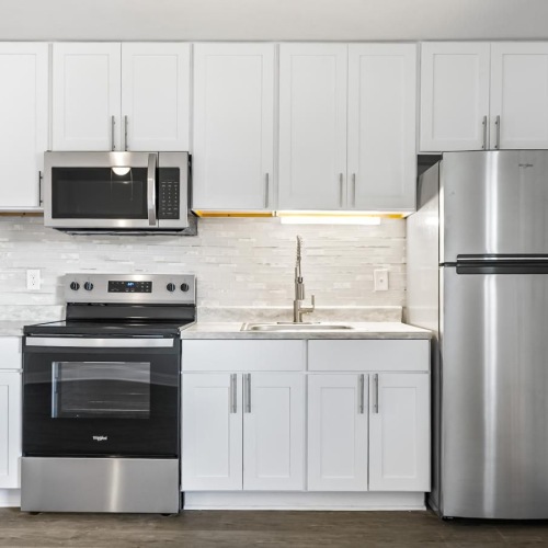 a kitchen with white cabinets