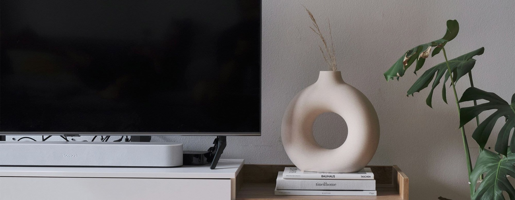 a tv on a stand with decor