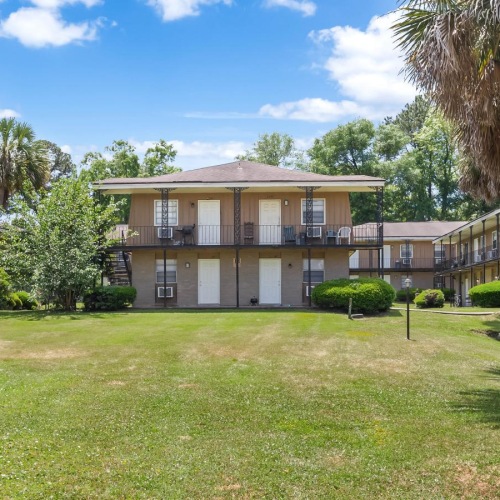 a building with a lawn and trees
